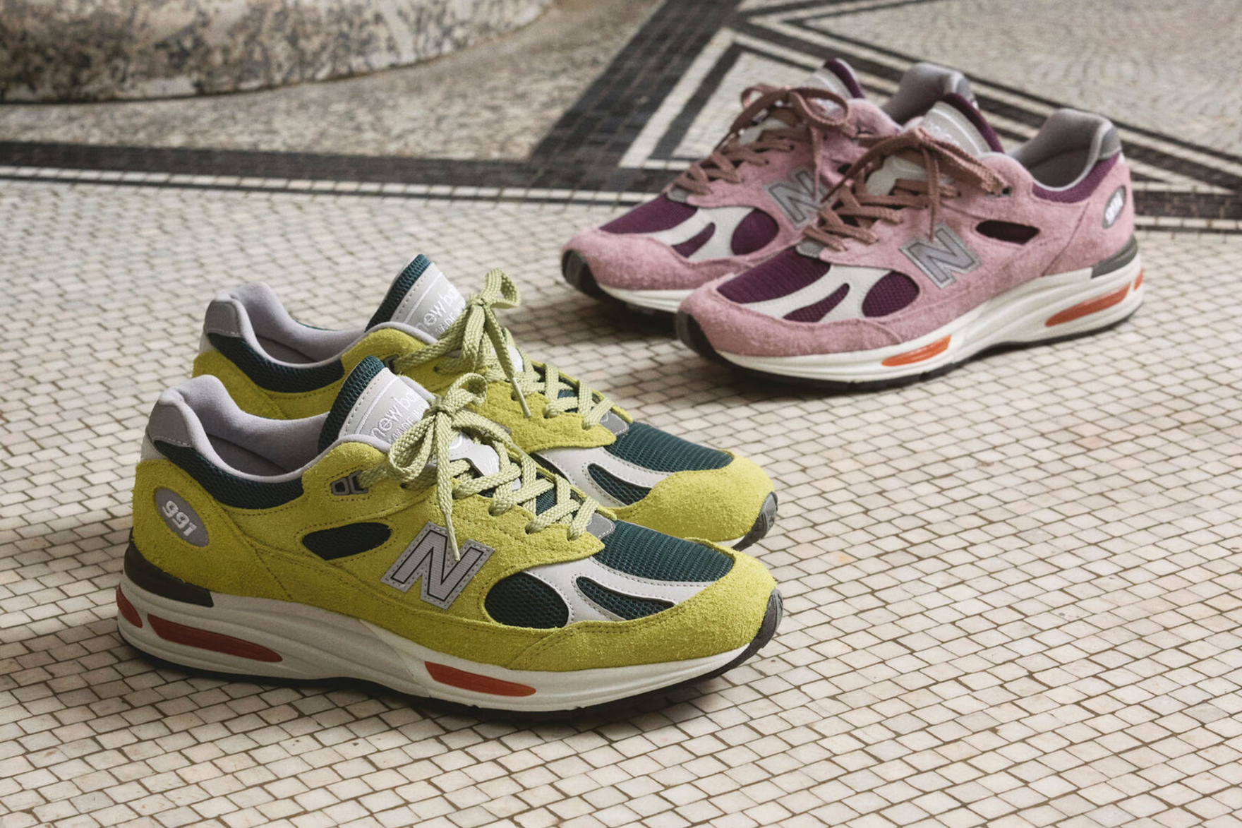 two new balance sneakers in green and pink