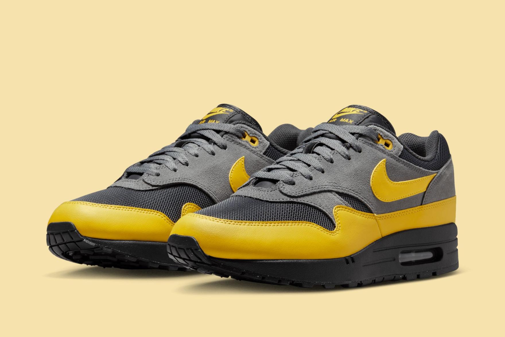 Black yellow and grey 'Batman' Nike sneakers on yellow background