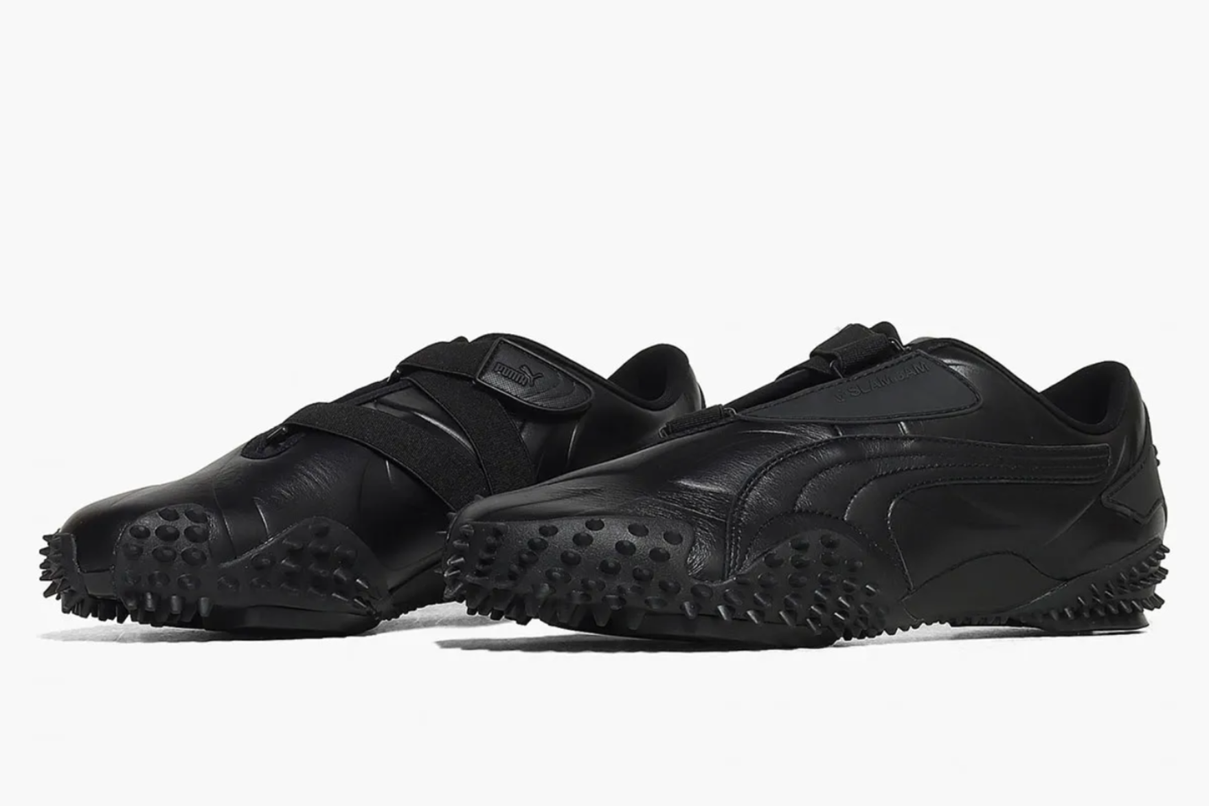 black puma mostro spiky sneakers on a grey background
