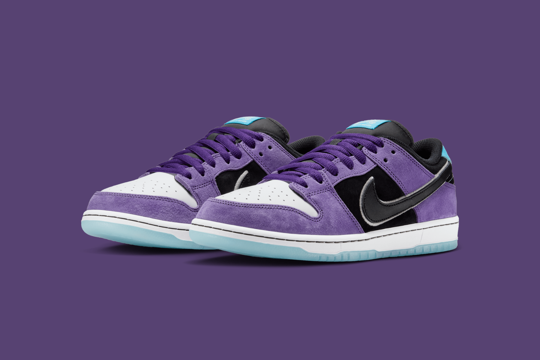 Purple, white and blue sneakers on a purple background