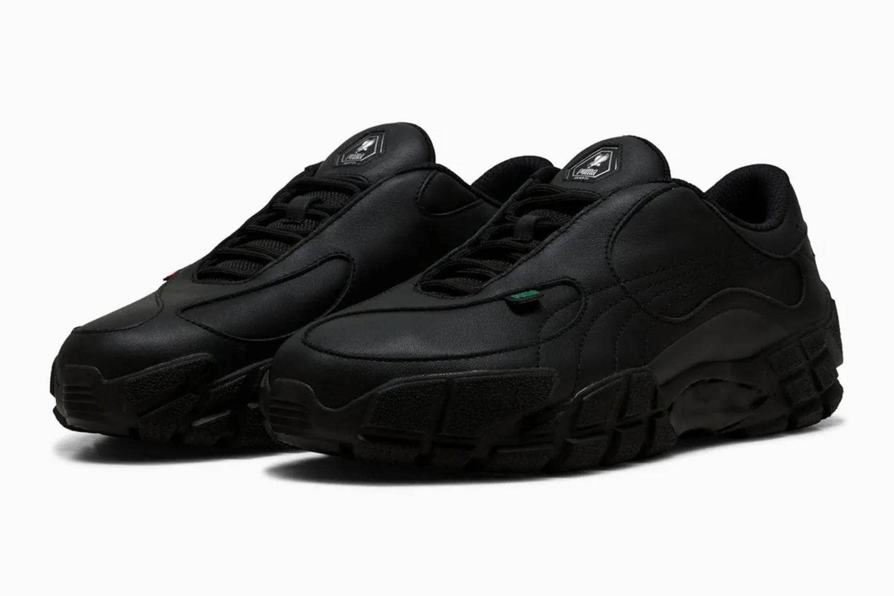 All-black sneakers sitting on a white background
