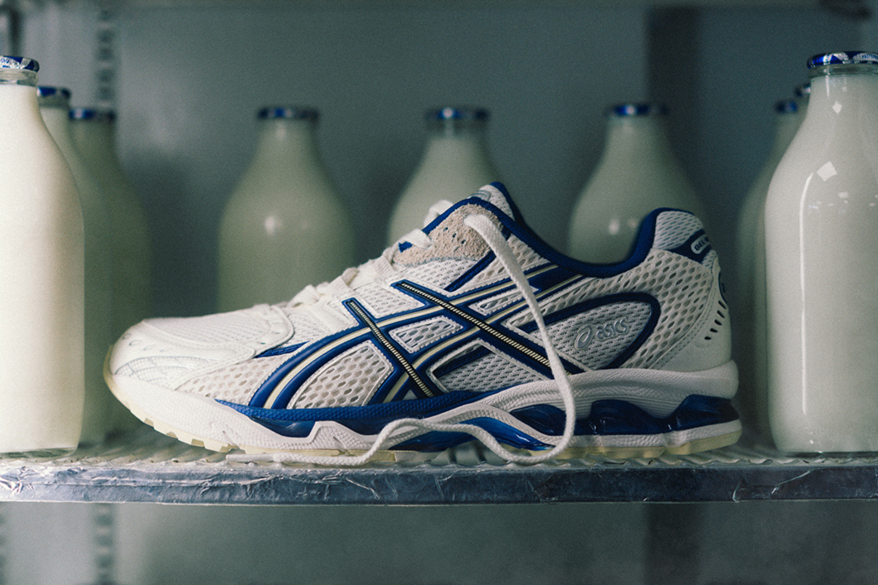 asics sneaker sat in a fridge filled with milk bottles