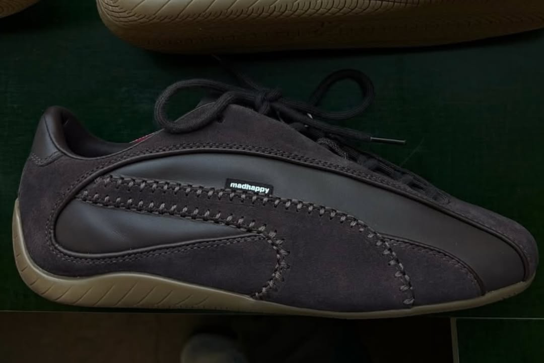 dark purple puma speedcat on green background
