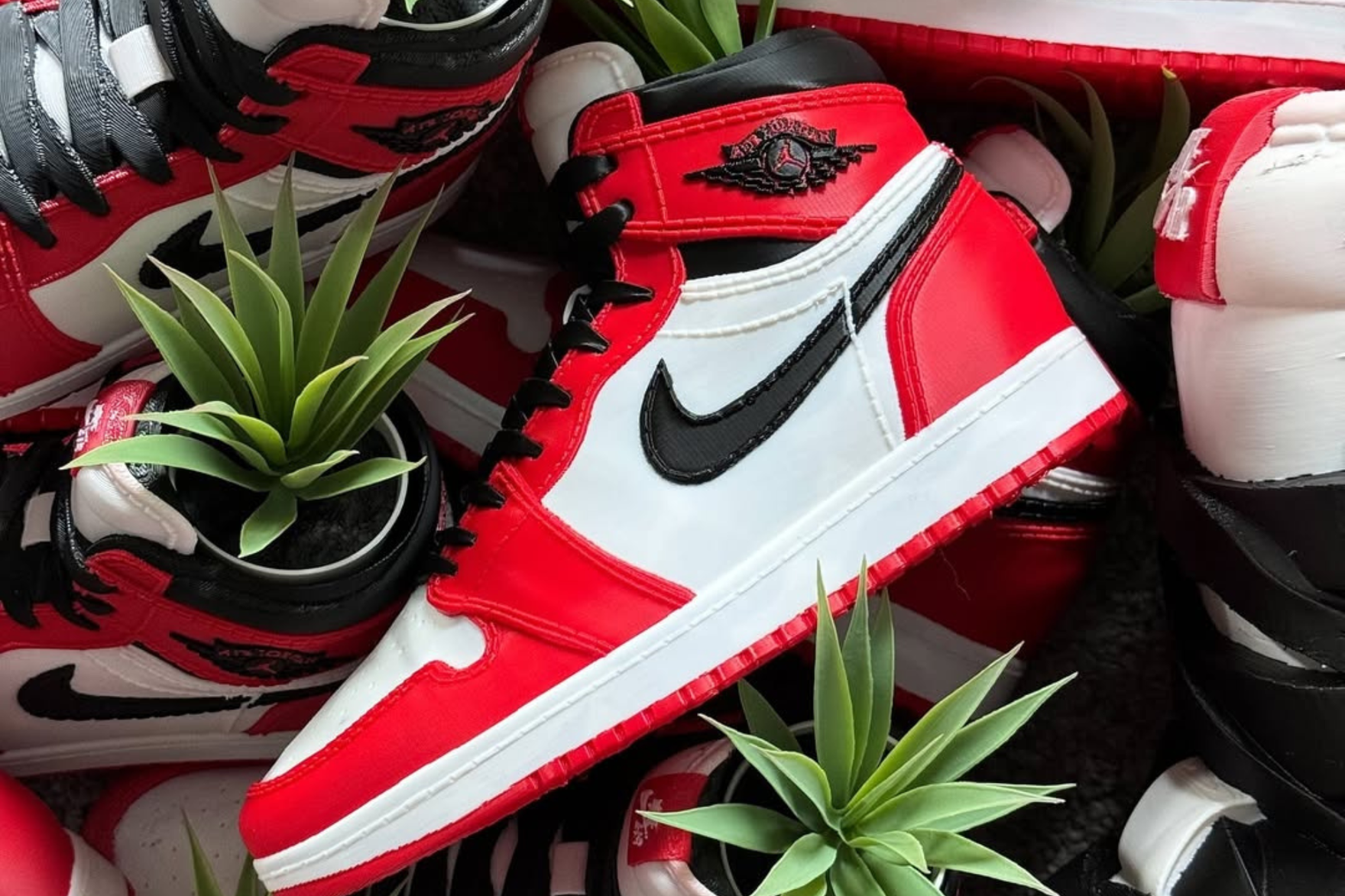 A 3D-printed Air Jordan 1 sneaker in Bred colourway with plant inside