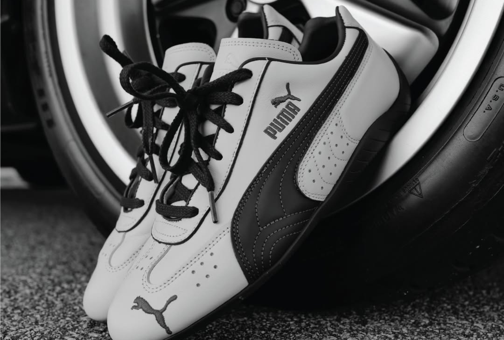 puma speedcat styled against tyre rim