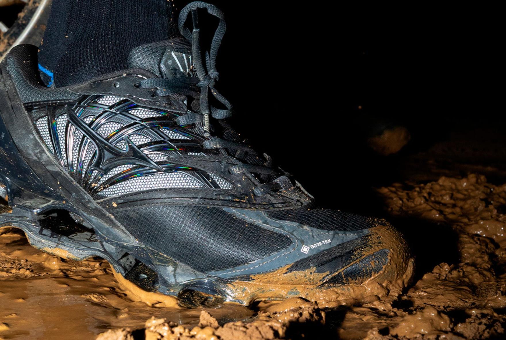 Black Mizuno Wave Prophecy LS sneaker stepping in mud