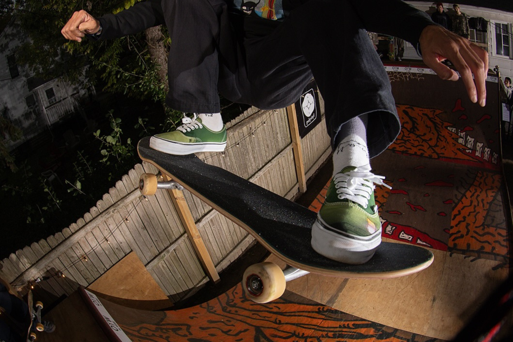 a guy skateboarding in a pair of green vans sneakers