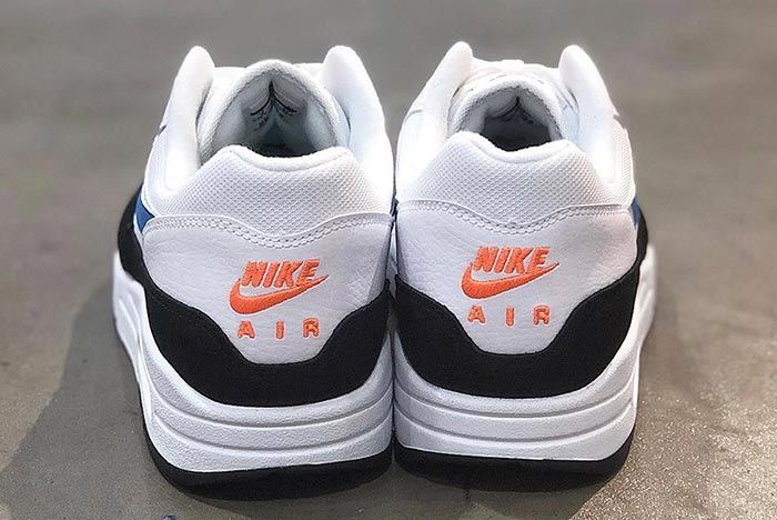 white nikes with orange heel