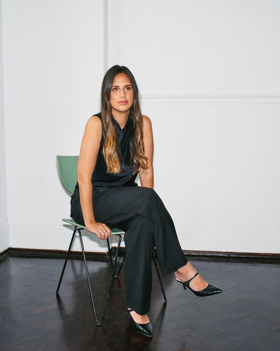 Portrait of Bianca Fincham sitting on green chair