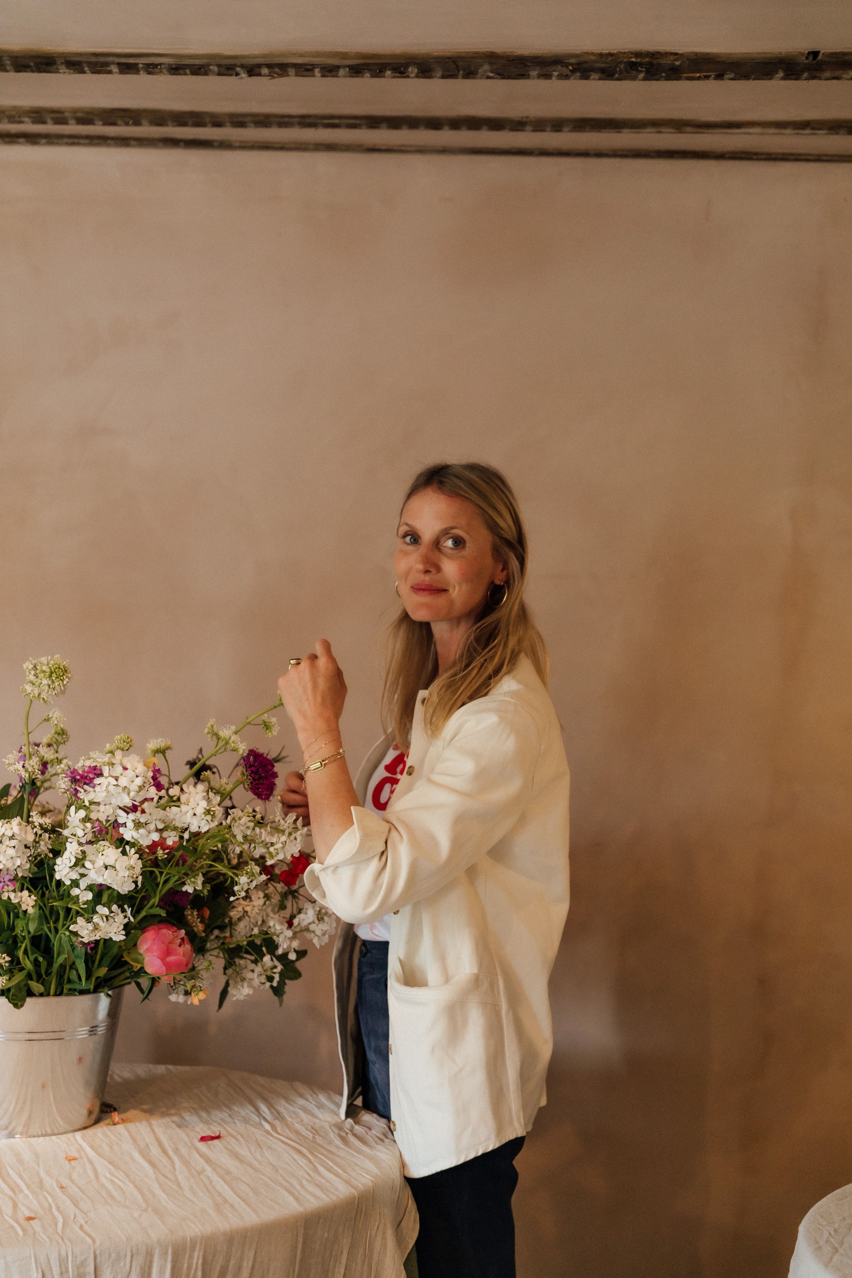 Florist, arranging a bunch of hand picked fresh flowers.