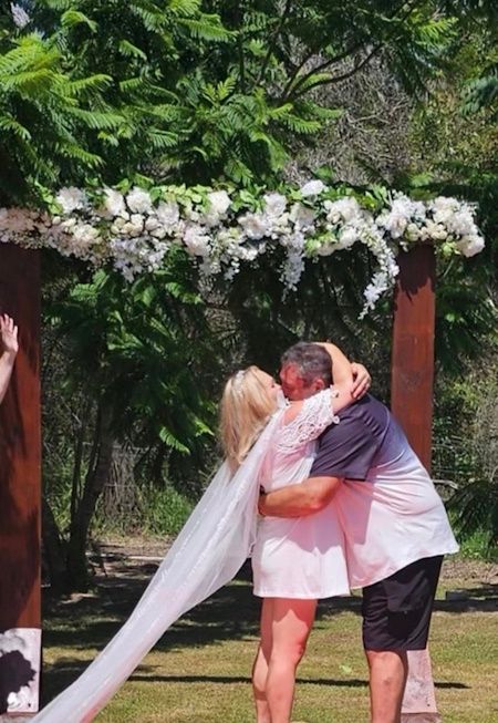 Newlyweds embracing after their outdoor ceremony