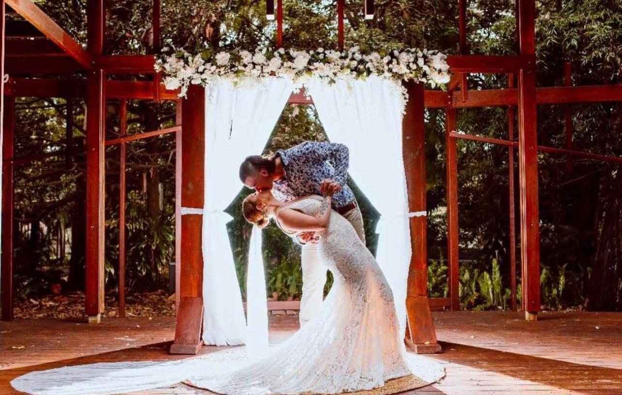 A couple sharing an emotional moment during an outdoor ceremony