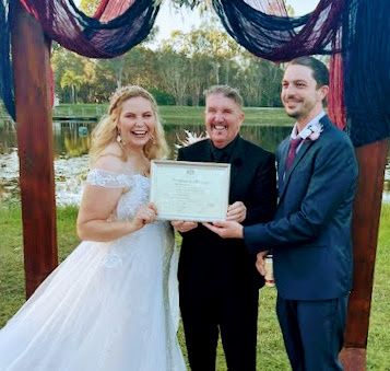 A couple celebrating with their ceremony certificate