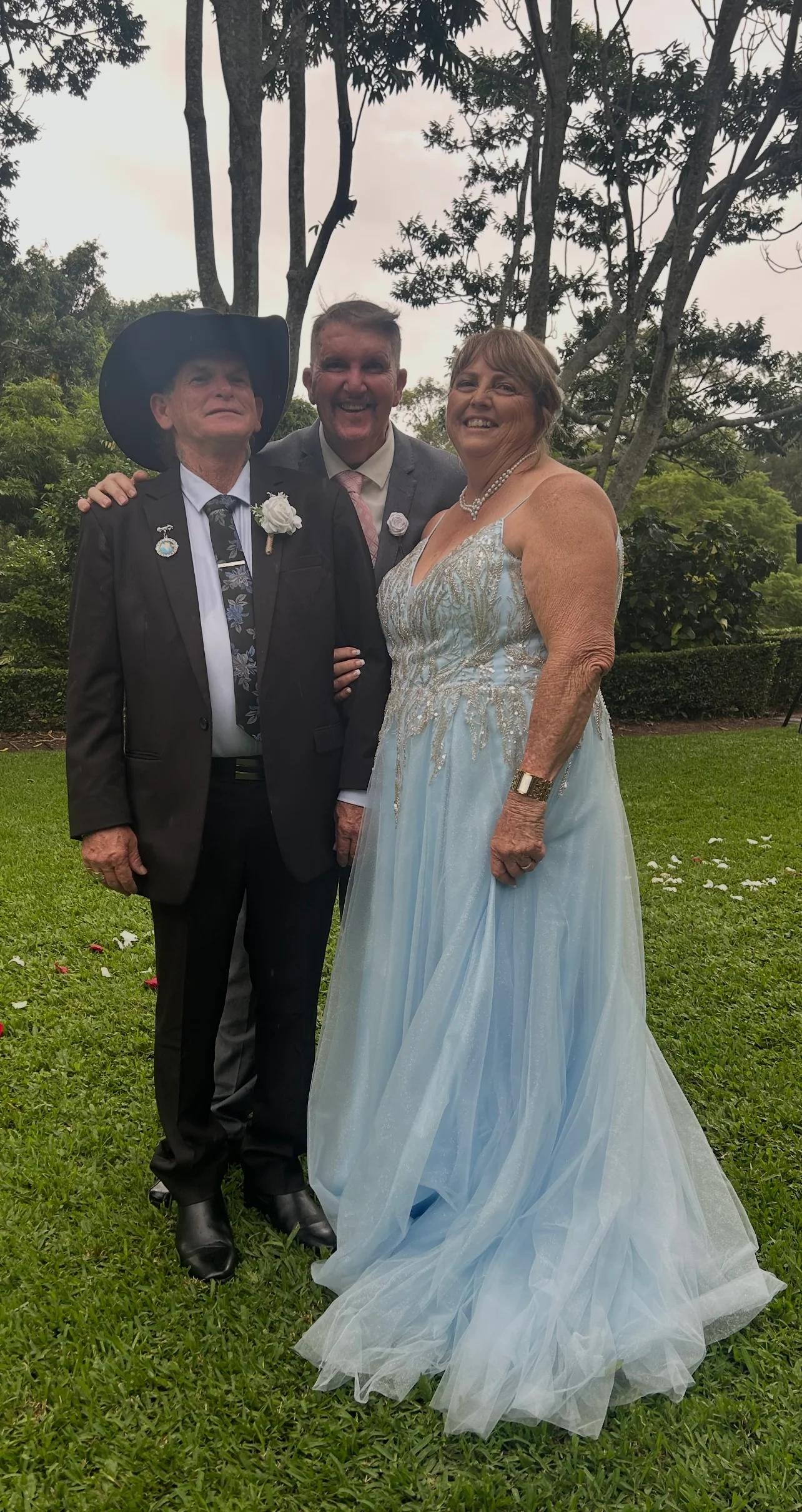 Mark sharing a relaxed outdoor moment with a couple
