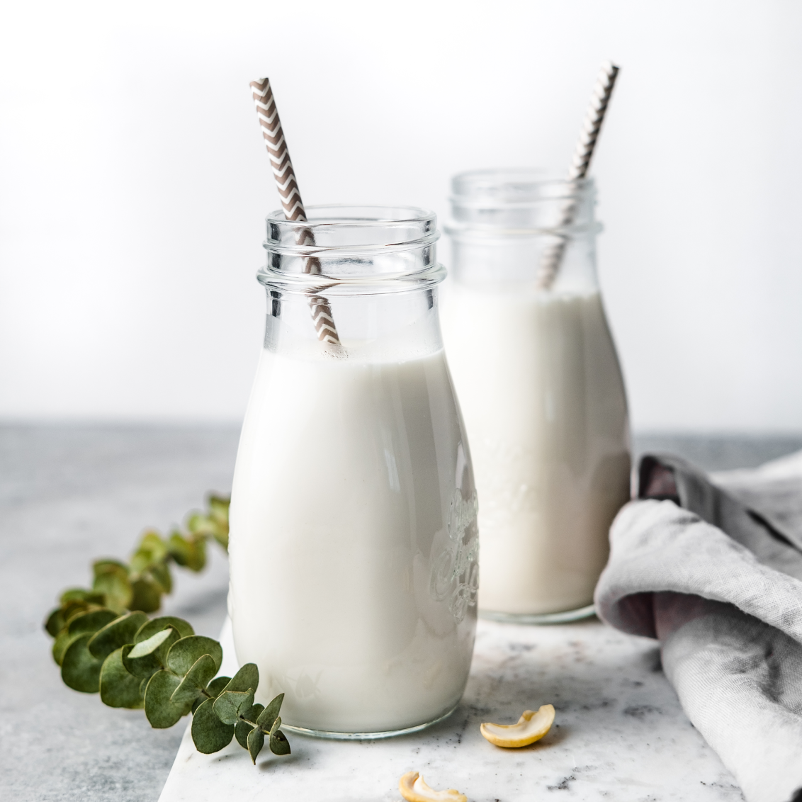 Creamy and frothy Pro Coconut Cashew Milk in glass milk jar
