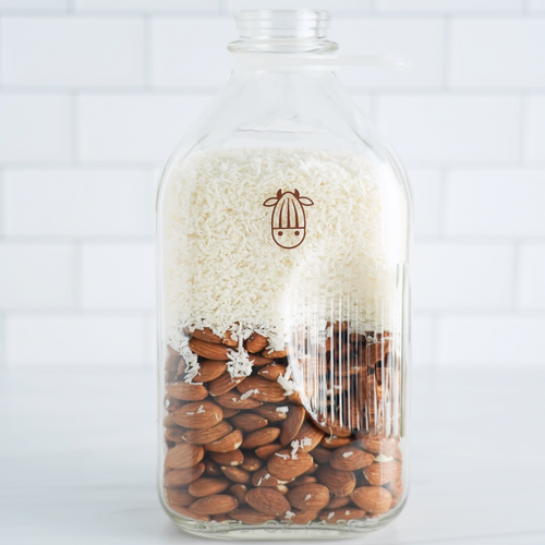 CocoAlmond milk in glass with almonds and coconut