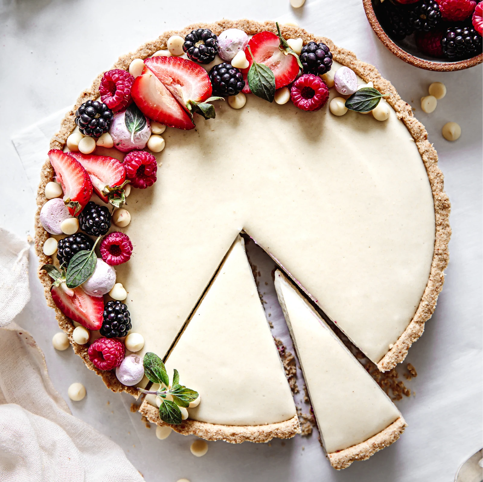 Almond Cow's White Chocolate Berry Tart garnished with fresh berries