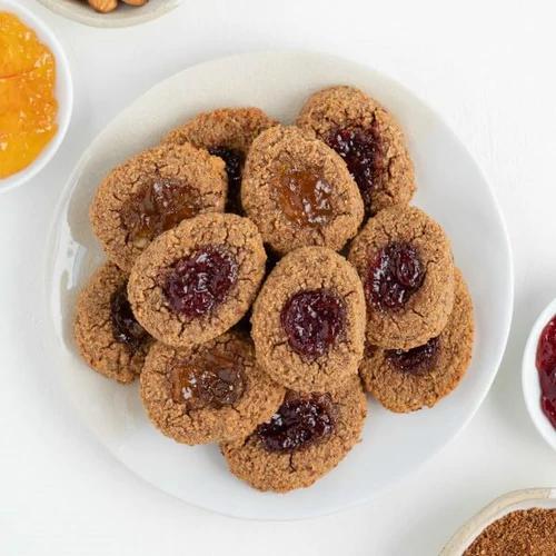 plate of vegan thumbprint cookies filled with jam