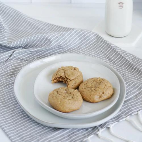 Golden brown Almond Cow Cashew Butter Cookies served with plant-based milk