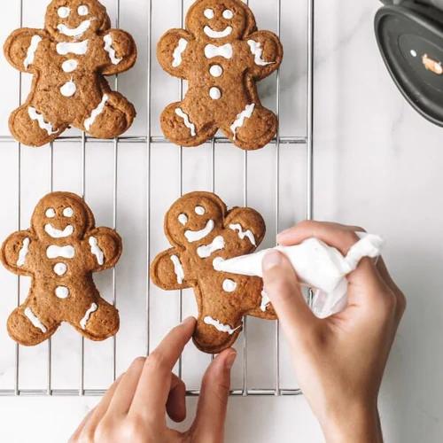Vegan gingerbread cookies being decorated
