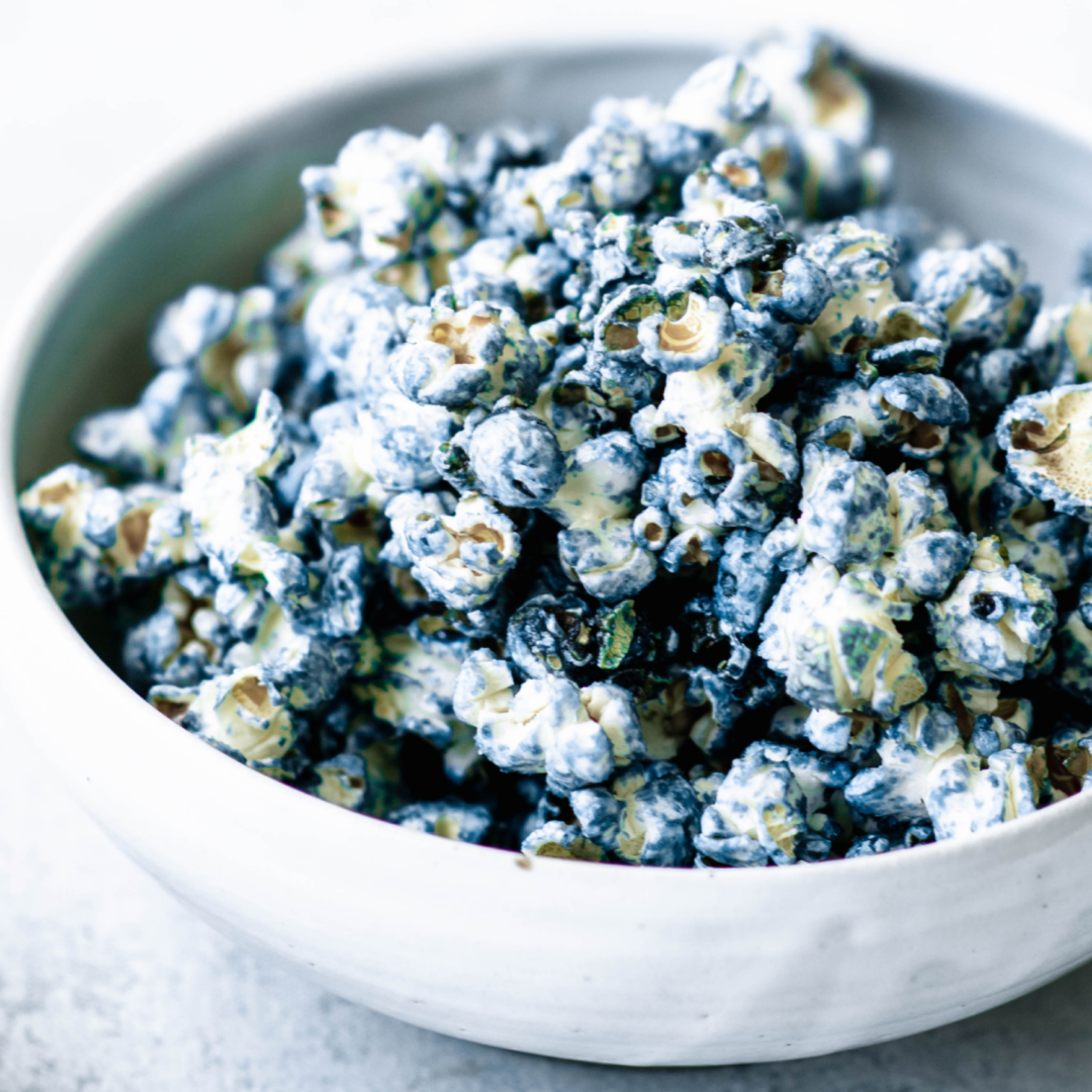 Blue popcorn colored naturally, having a balance of sweet and salty flavors, made healthily with Almond Cow's vegan butter