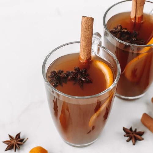 Mulled Cider with a cinnamon stick and orange peel