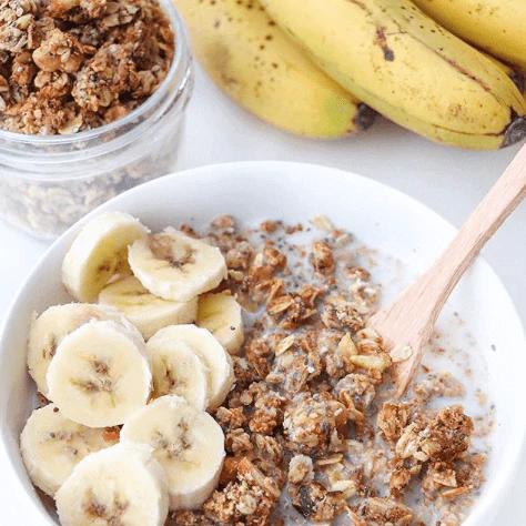 Almond Pulp Granola with fresh banana slices and plant-based milk