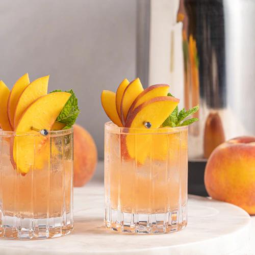 Bourbon Peach Smash cocktail recipe by Almond Cow, showcasing fresh peaches and mint