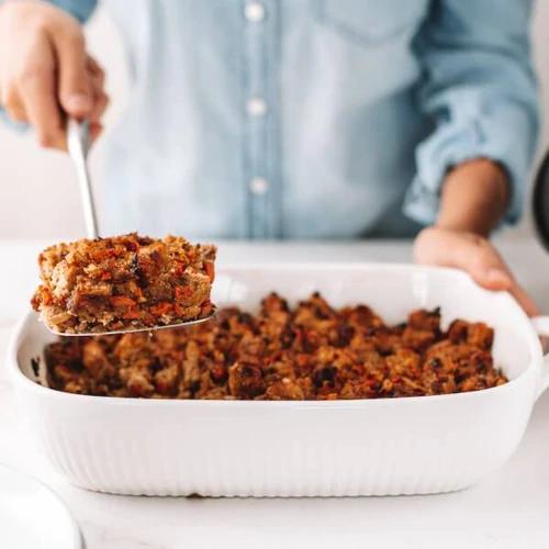 Thanksgiving stuffing made with creamy hazelnut pulp in a white casserole dish
