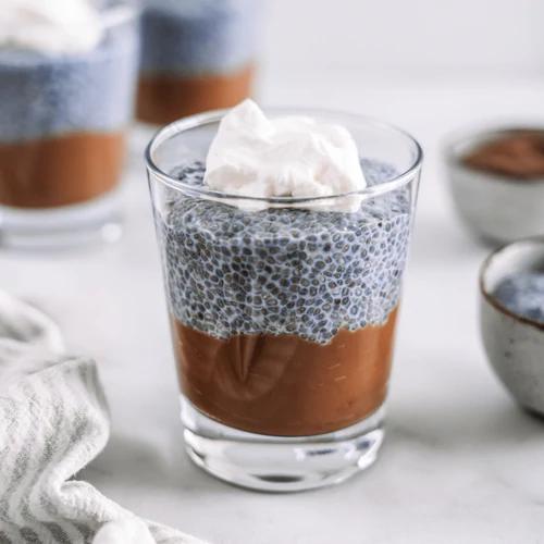 Triple Layered Dessert with chocolate base, blue chia pudding, and coconut whip cream by Almond Cow