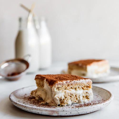 Gluten-free vegan Tiramisu next to almond milk glasses, perfect indulgent dessert