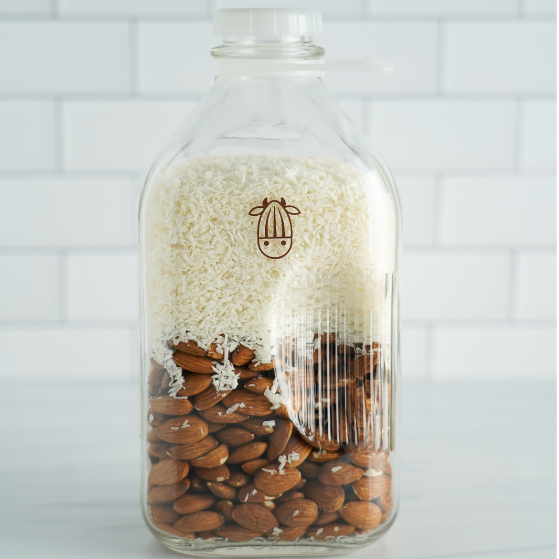coconut shreds and almonds in the Almond Cow Glass Jug