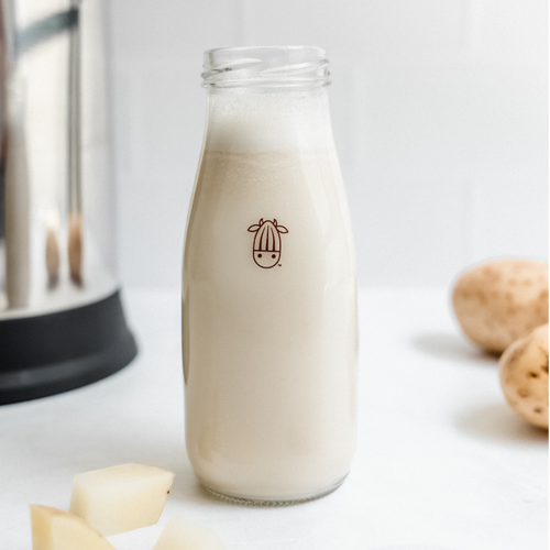 Creamy and delicious potato milk in a clear glass, made with Almond Cow's machine