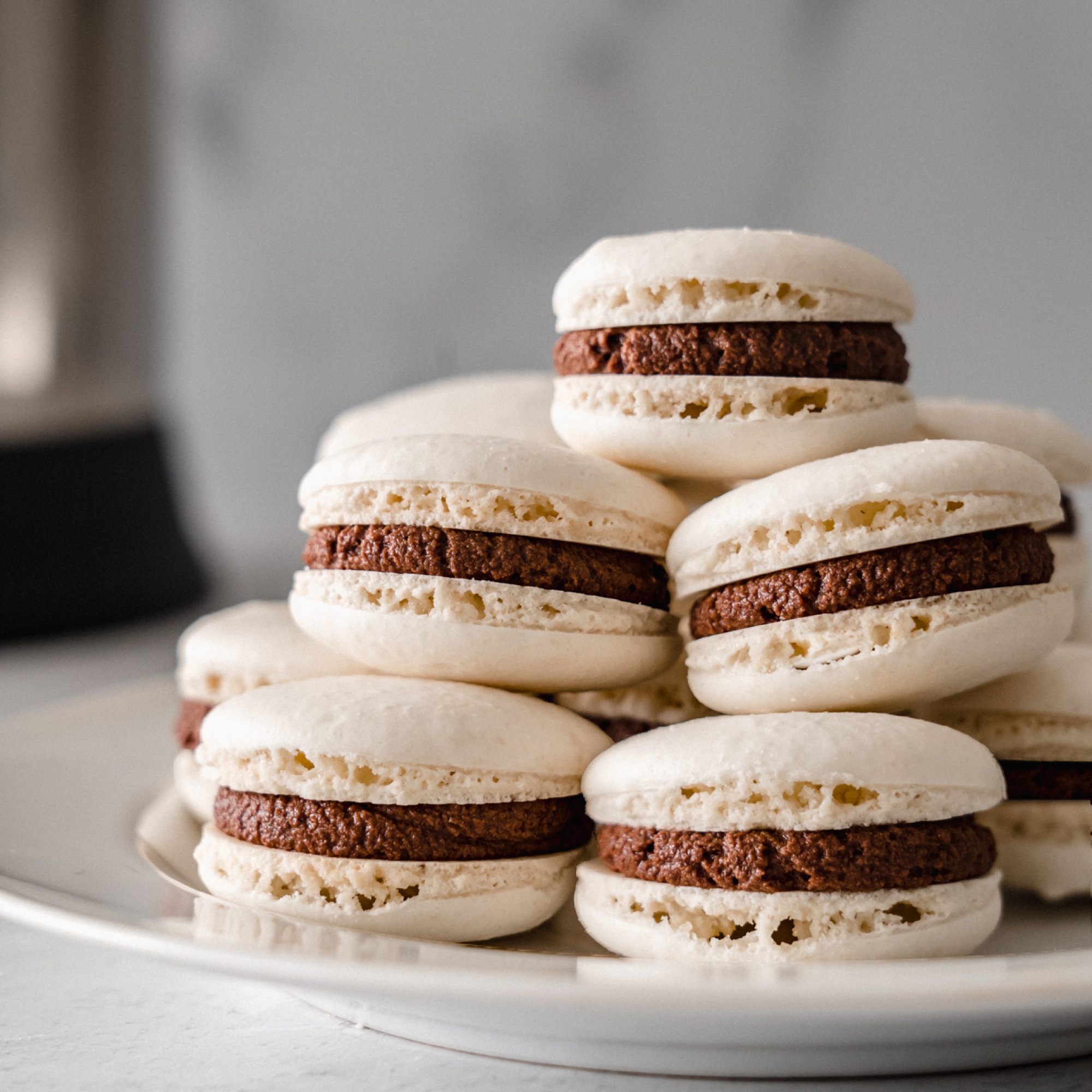Enjoy these beautiful and delicious French Macarons. Featuring almond milk made in your Almond Cow. A classic delicate sandwich cookie filled with a decadent chocolate buttercream filling. 