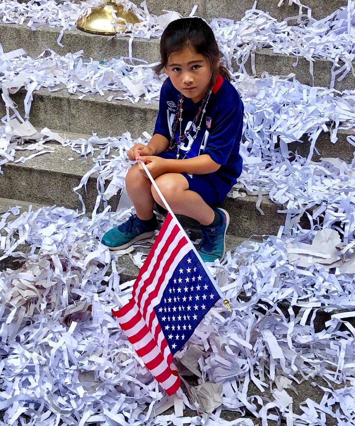 Young girl sitting in confetti