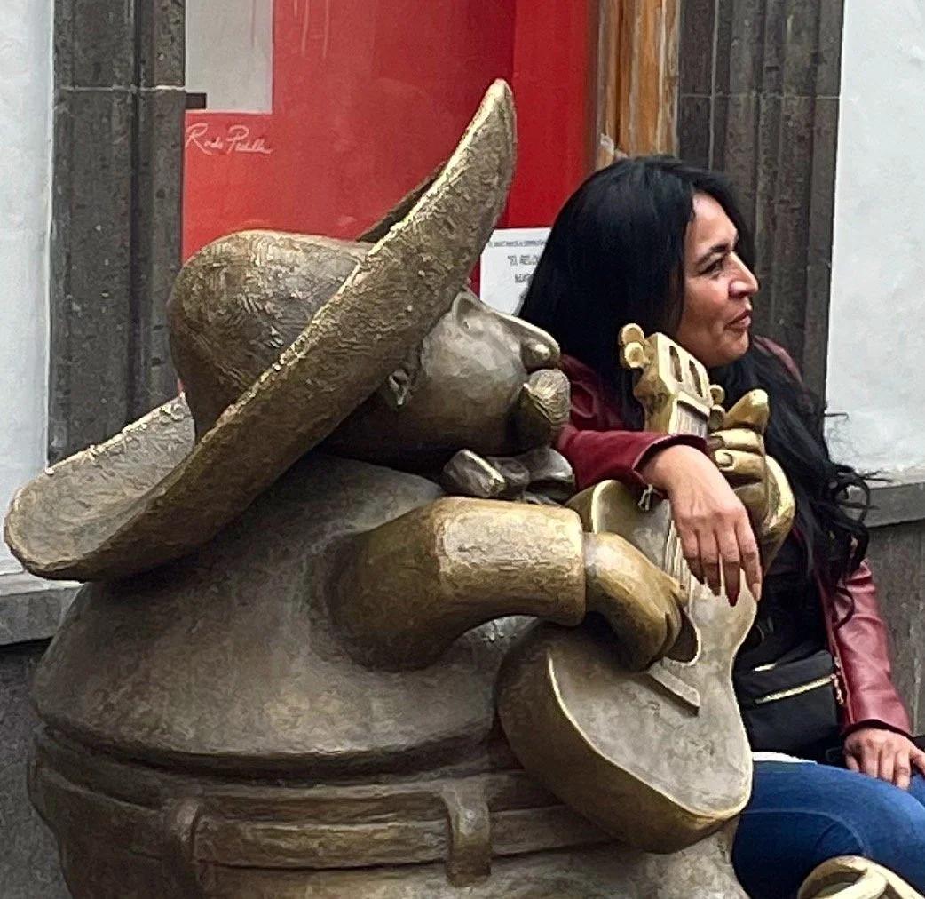 Woman sitting wth statue