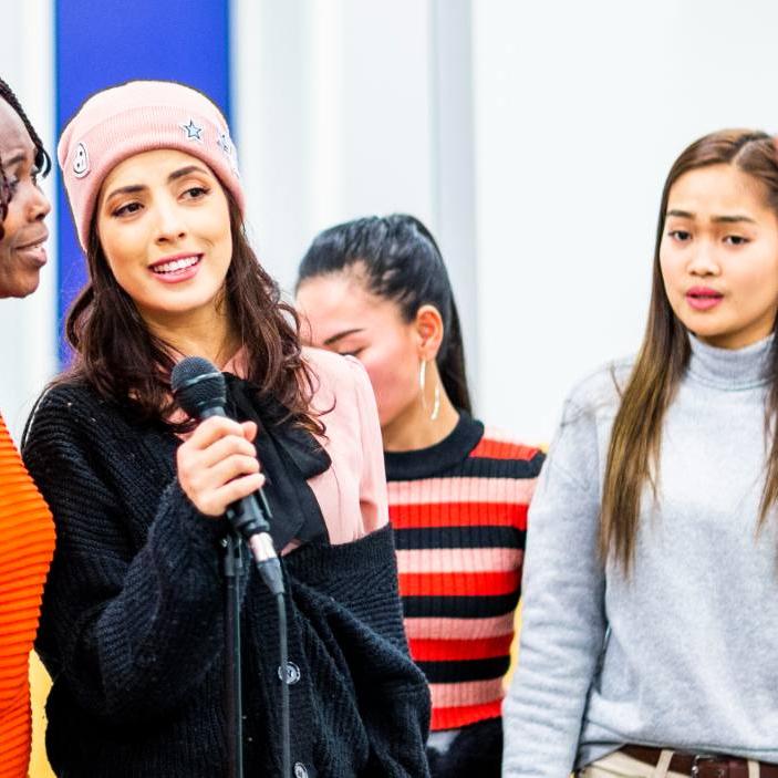 Mennesker med ulik etnisk tilhørighet synger sammen.