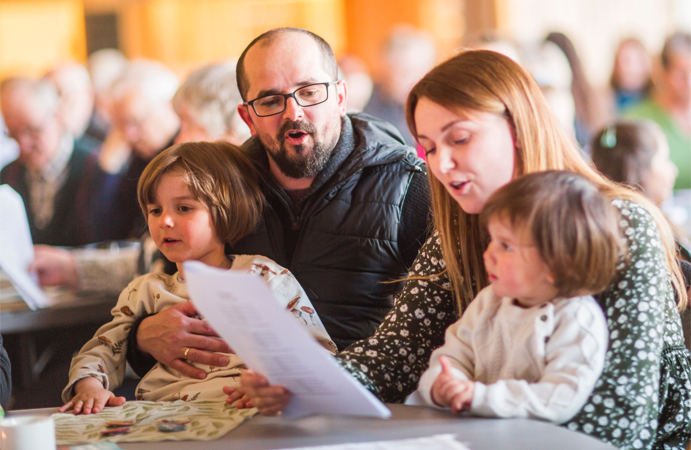 Familie synger sammen på et arrangement i regi av en Syngende kommune.
