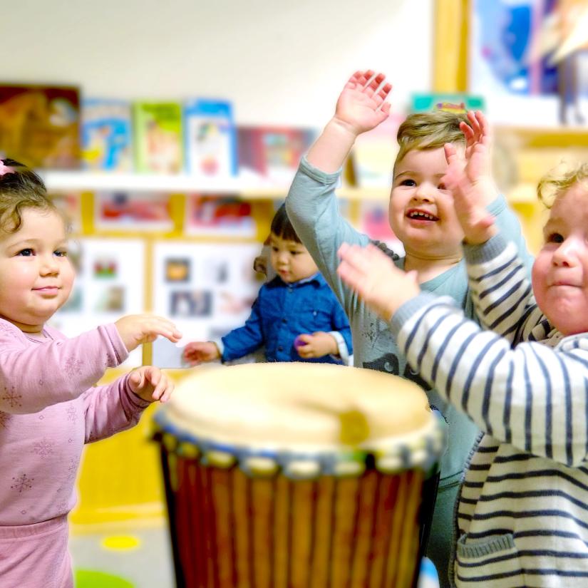 Barn synger og slår på trommer