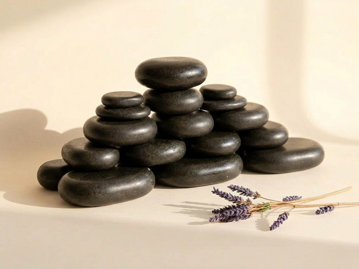 Black massage stones in a pile