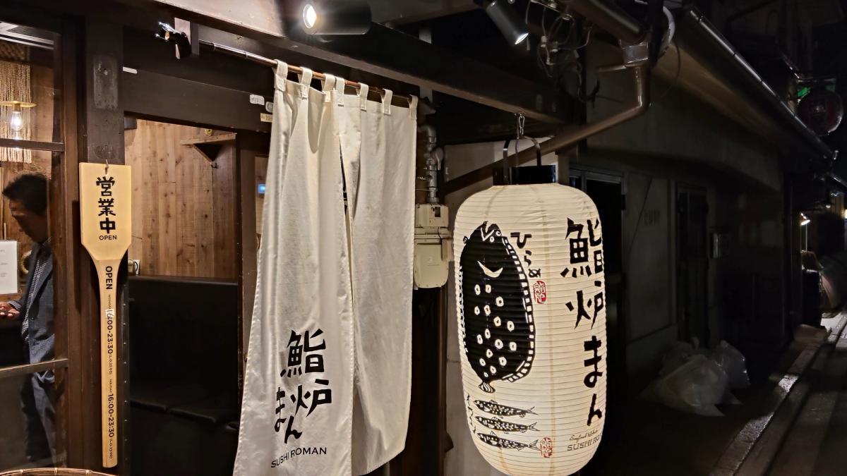 路地に灯る「鮨炉まん」の暖簾と提灯