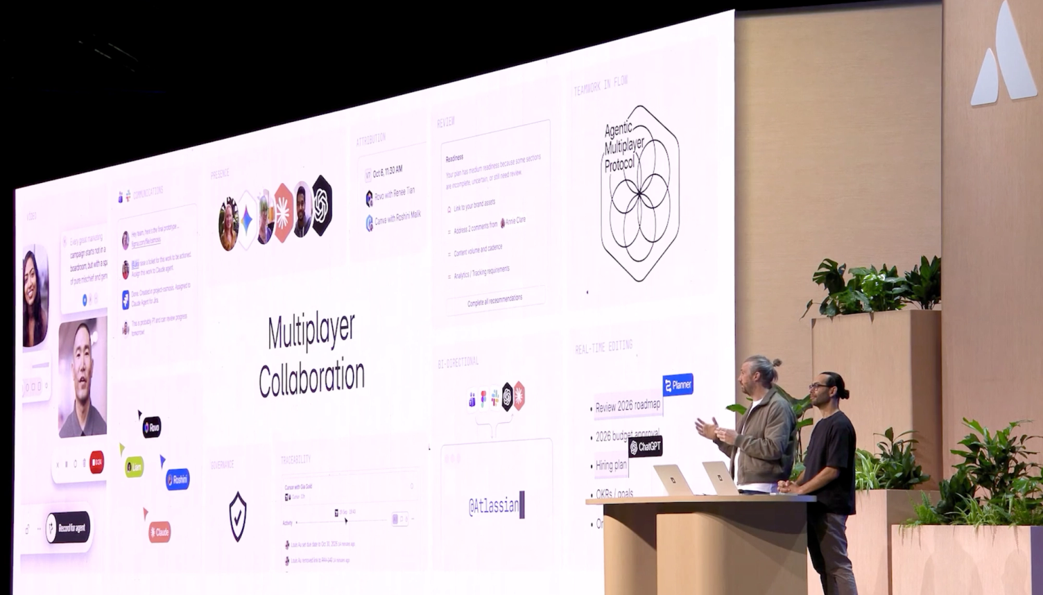 Two presenters on stage with a slide about multiplayer collaboration and AMP.