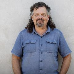 Jan Falkenreck, Head of Research and Development at Get AG, smiling in front of a light wall
