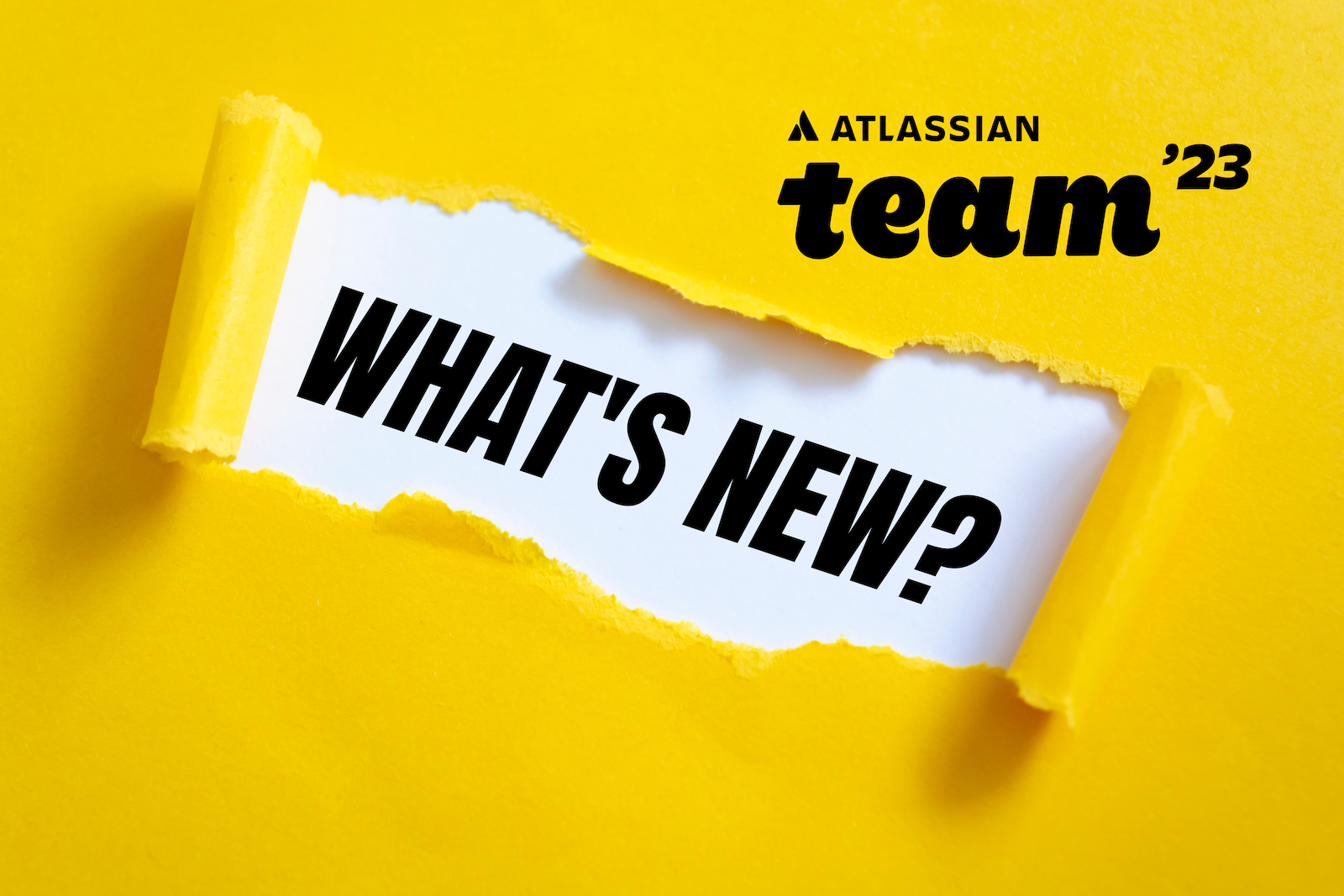 Atlassian Team 23 Banner: gelbes Papier aufgerissen, darunter WHAT IS NEW mit Atlassian Team 23 Logo oben rechts.