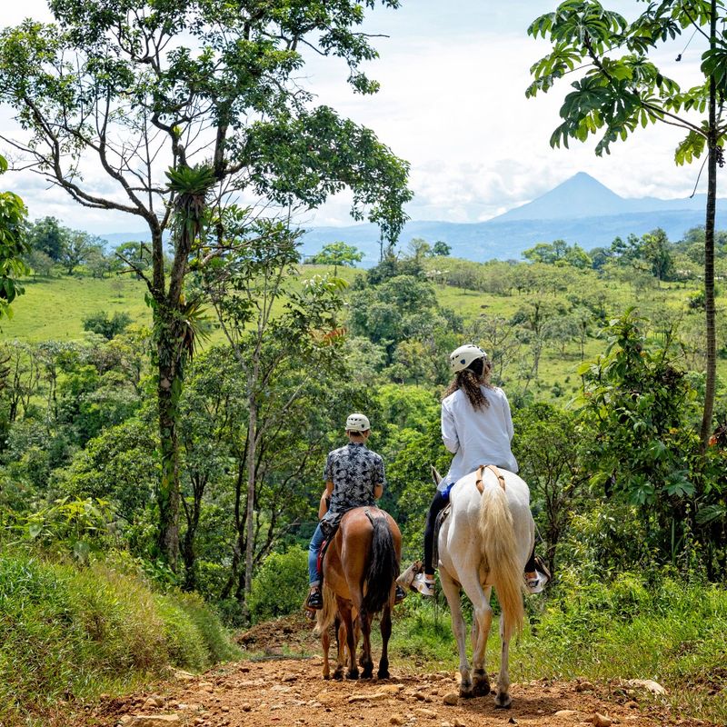 Guests horseback riding on private trails with Tenorio Volcano views in Bijagua, Costa Rica
