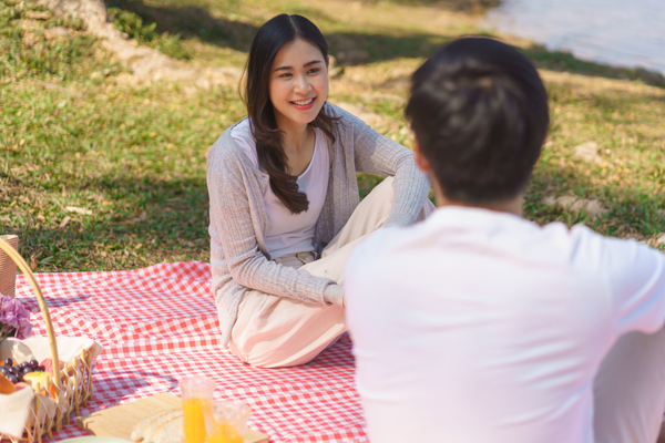 Couple eating a picnic on a picnic rug