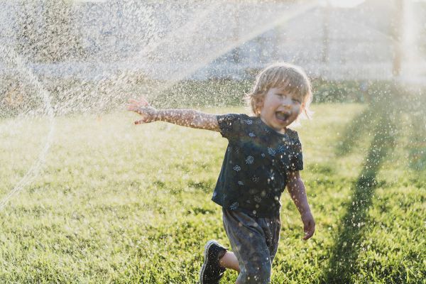 Galapagos tortoise being hosed down by children