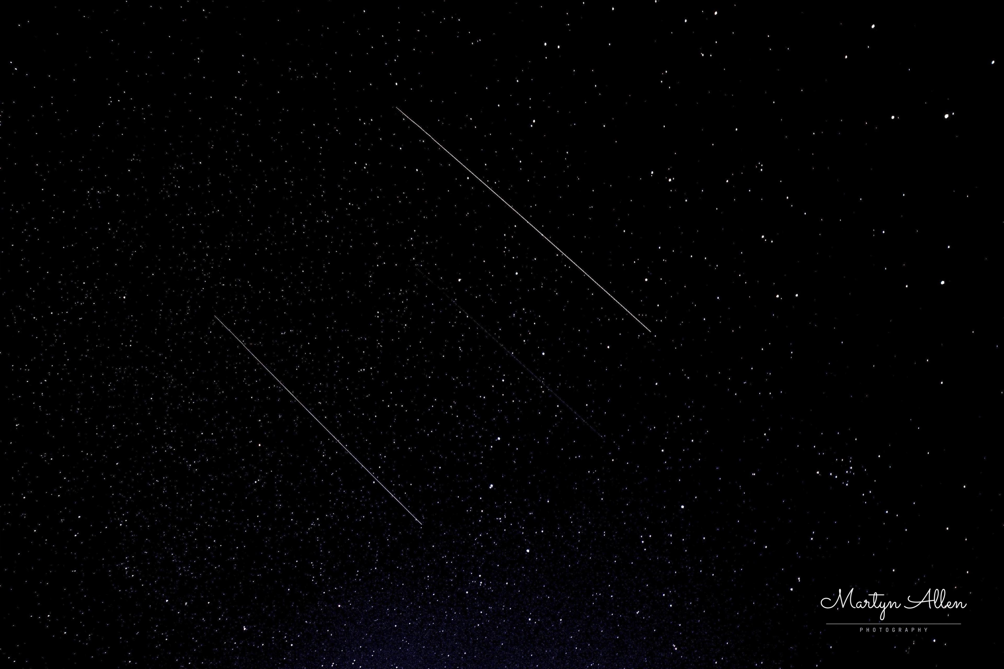 Two parallel trails crossing together, most likely a Starlink satellite train, caught during a 30-second wide-field exposure.