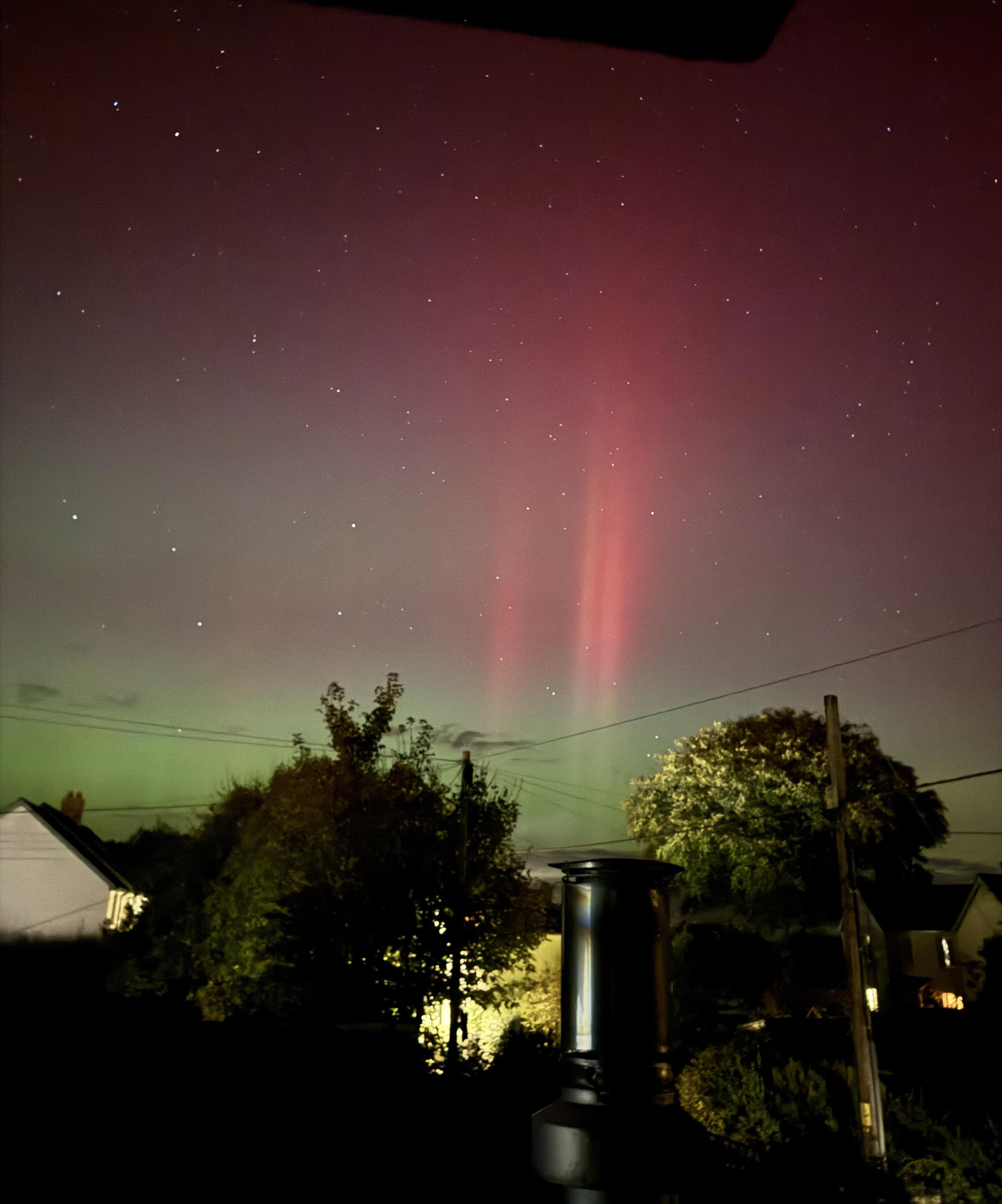 Twin red pillars over Northlew, Devon, from the same October 2024 aurora — cropped from the original frame.