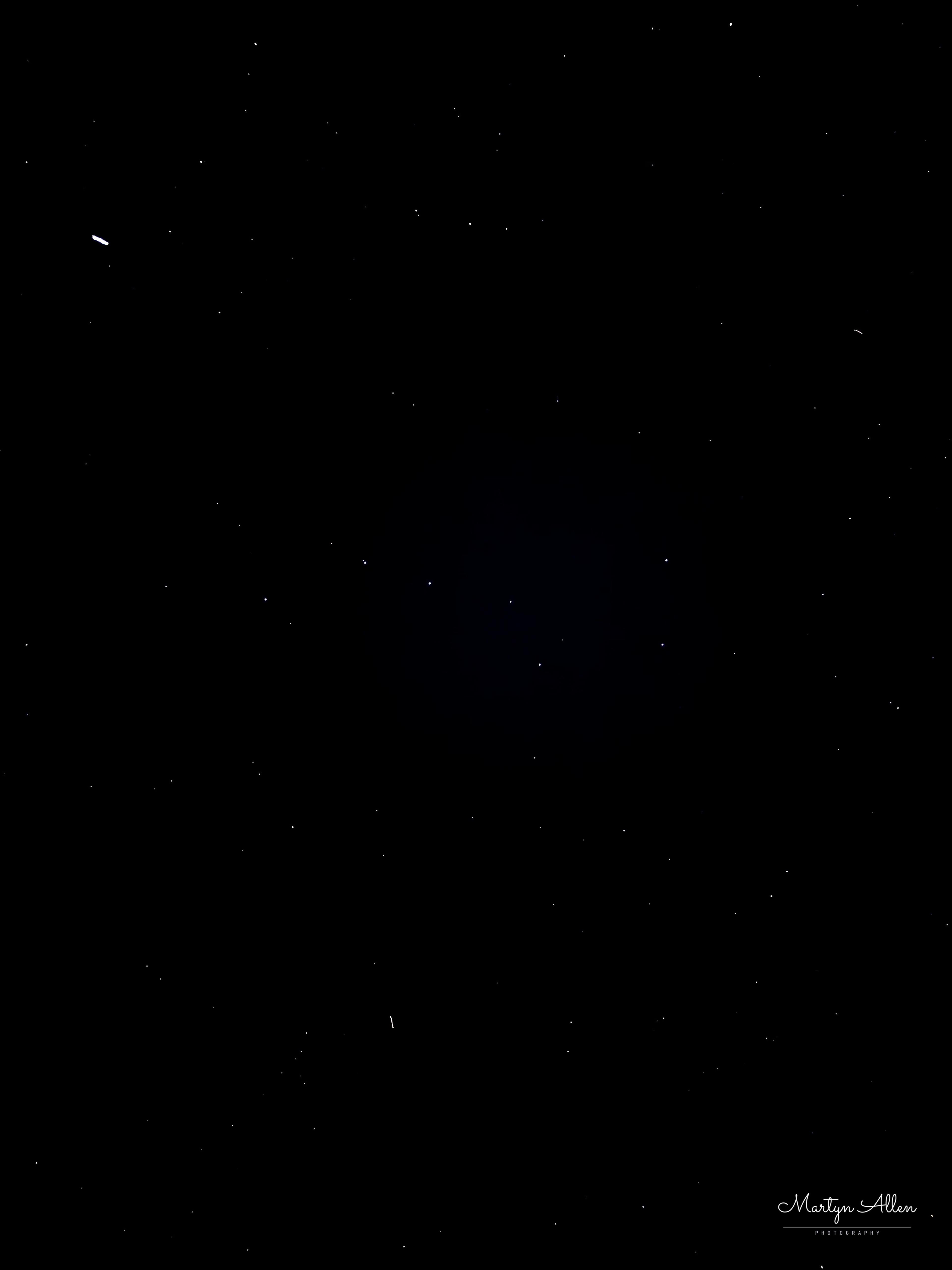 Two satellites crossed the frame during a quick iPhone night-sky test — an honest look at what a single 1-second exposure can and can't pull out of a dark sky.